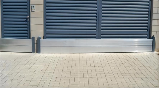 INOVA AL mobil översvämningsbarriär monterad framför dörr och garageport.